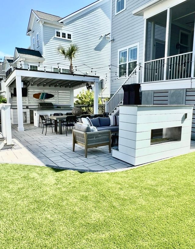 Backyard pavilion with outdoor kitchen and fireplace