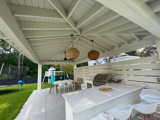 A-frame structure with outdoor kitchen and yard