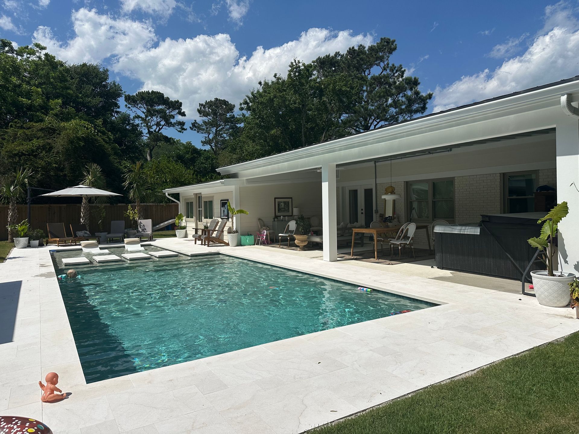 Pool with white covered patio and lounge