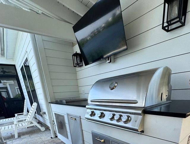 Outdoor grill station with TV