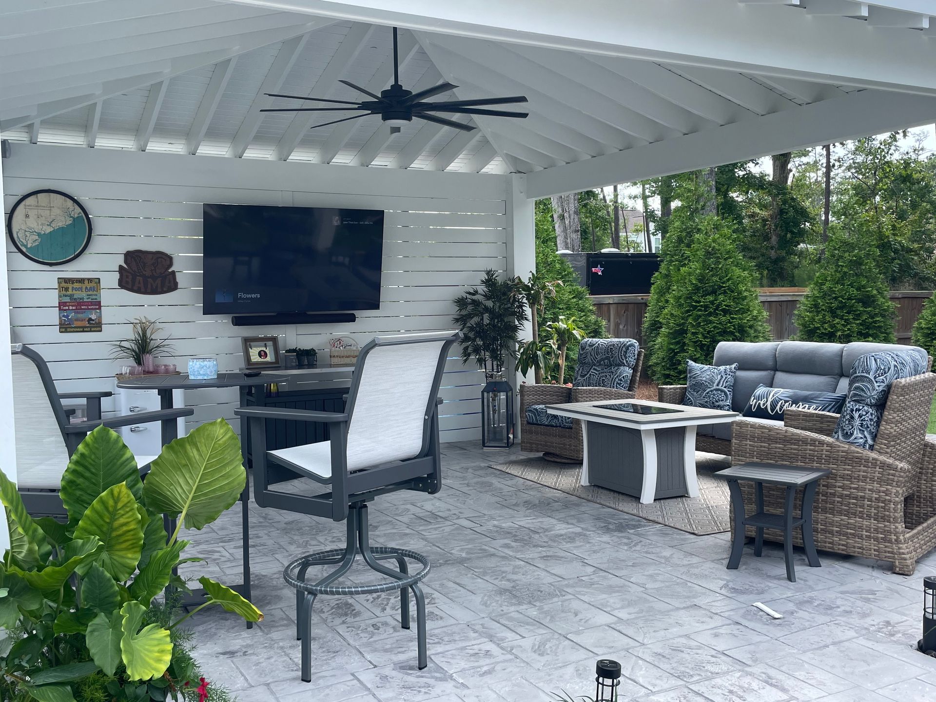 Covered outdoor lounge with TV and fire table