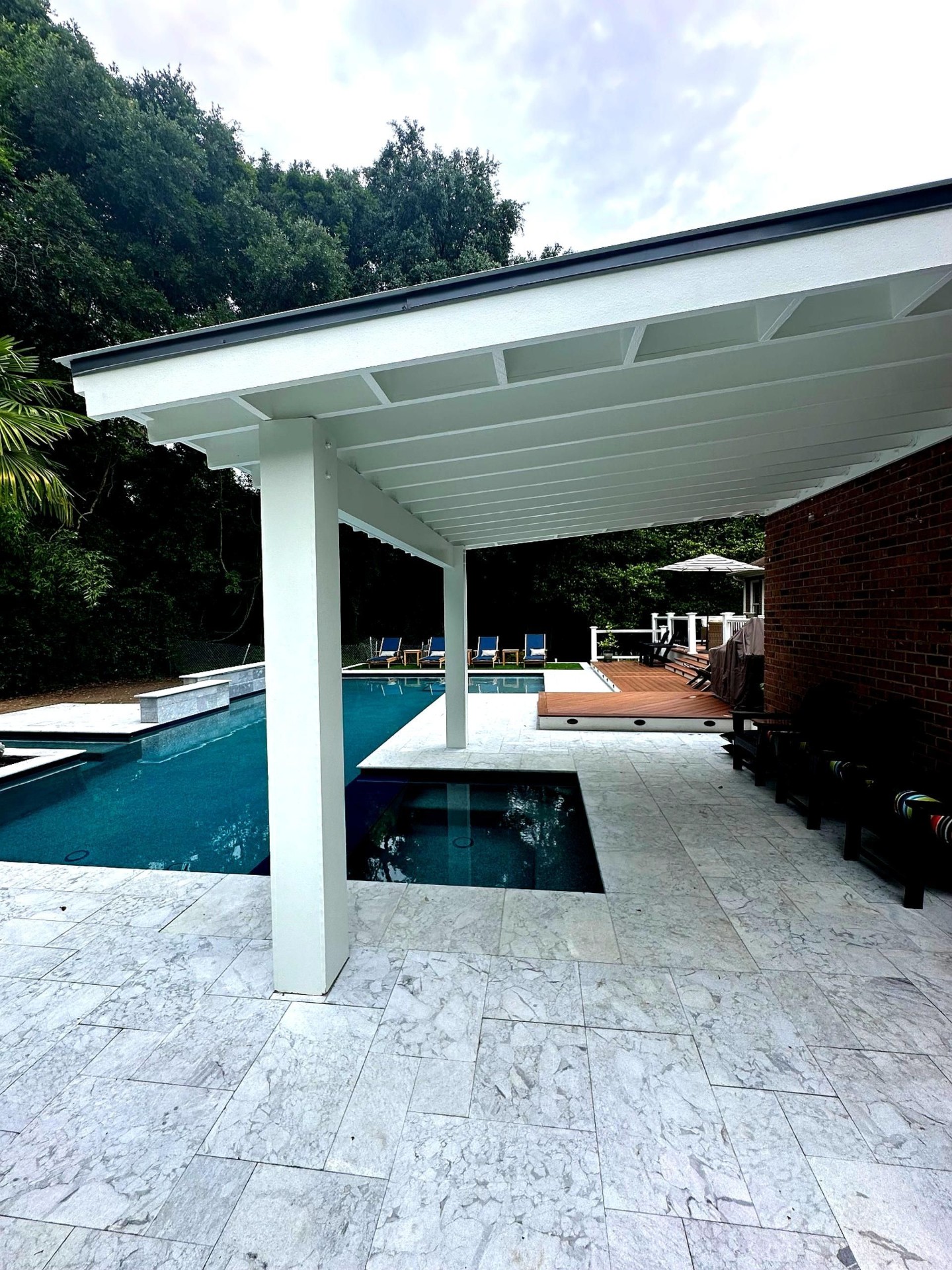 Covered pool pavilion with travertine deck