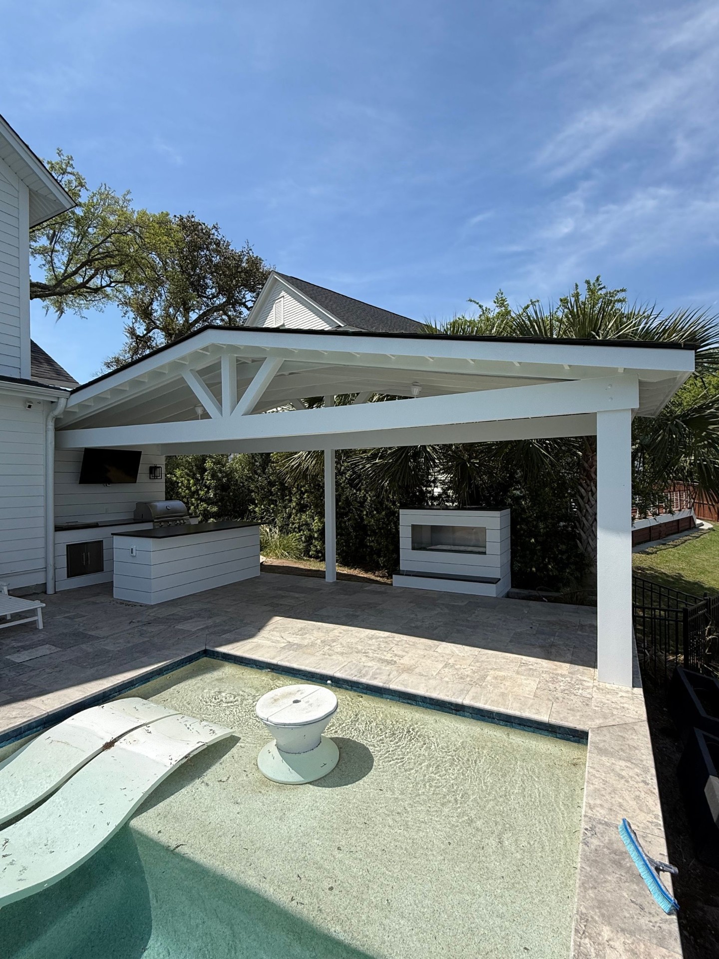 Pavilion with outdoor kitchen and modern fireplace