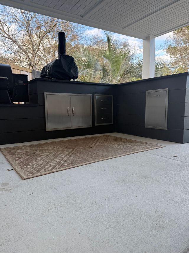 Black outdoor kitchen with smoker